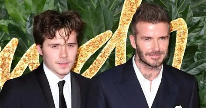 Brooklyn Beckham with his father