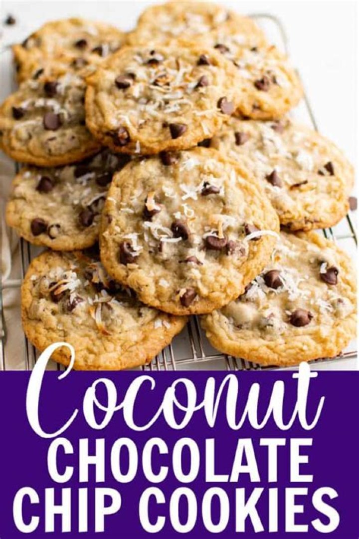 Coconut chocolate chip cookies piled on a round white plate.