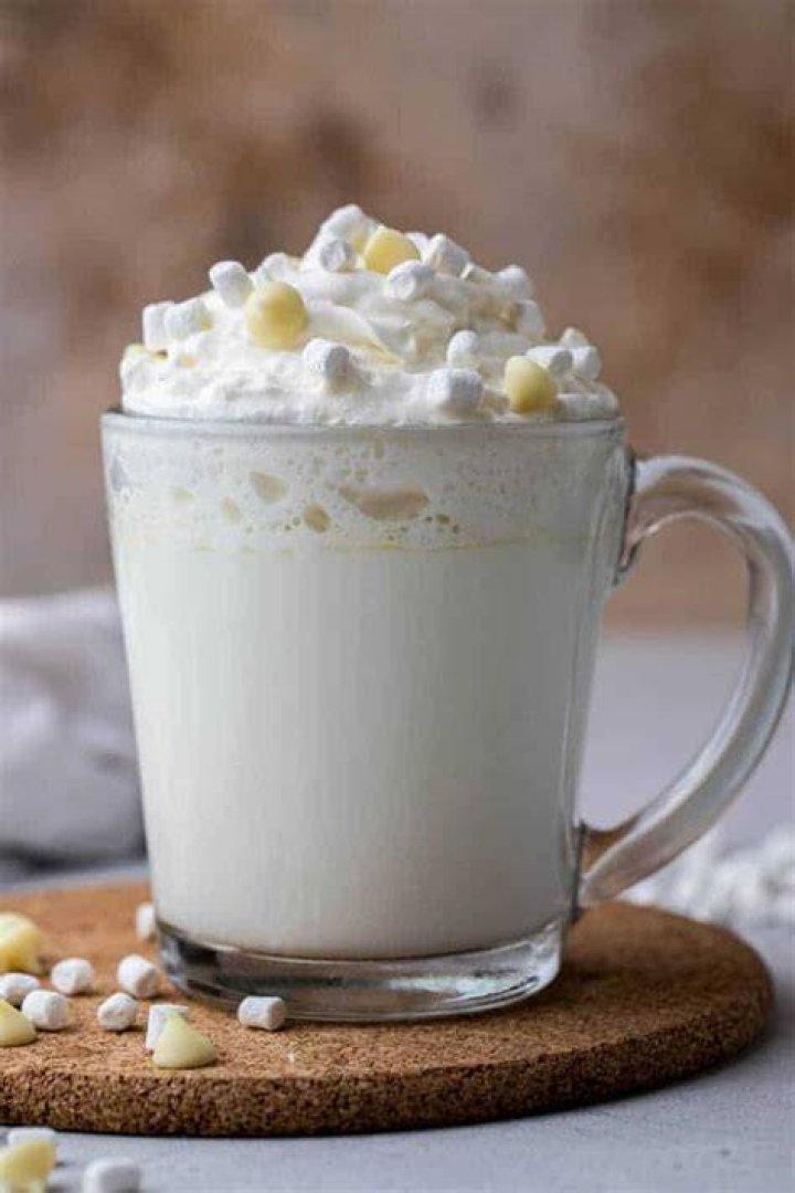 Hot chocolate in a white mug topped with marshmallows.