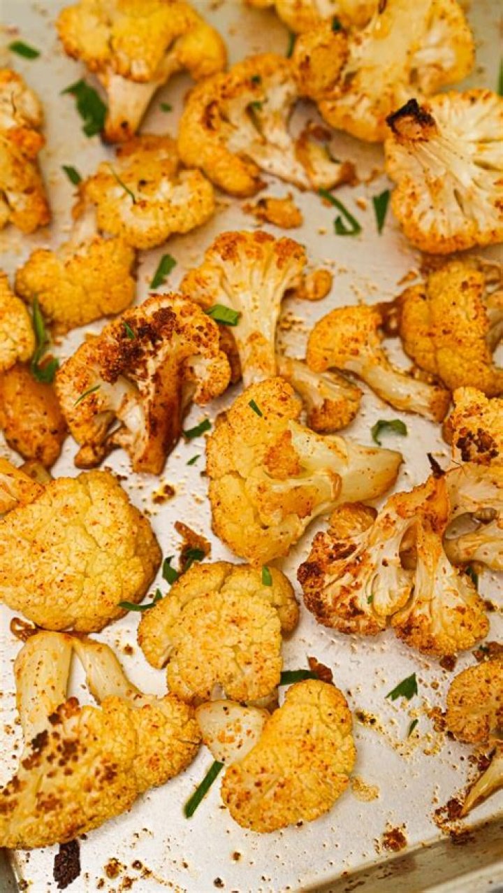 Roasted cauliflower on a baking sheet.