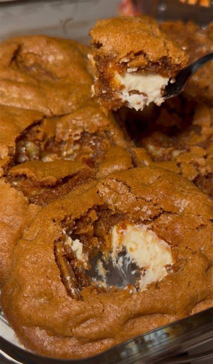 Scoops of cinnamon roll cookie dough on a white plate.