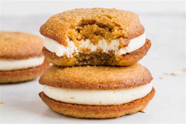 Stack of two oatmeal cream pies with a bite taken out of the top one.