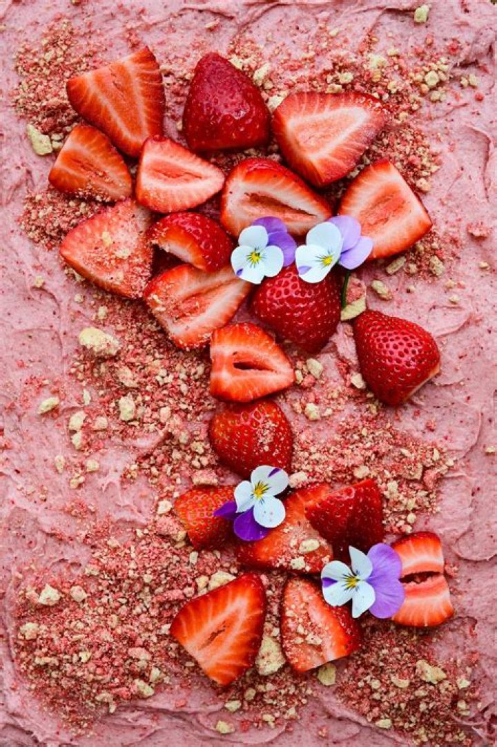 Strawberry sheet cake in a metal baking pan.