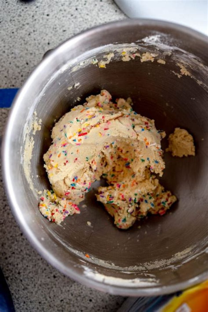 Sugar cookie dough in a white bowl.