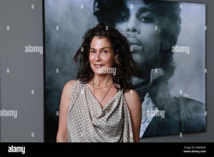 Susannah Melvoin in a white coat poses for a photoshoot.