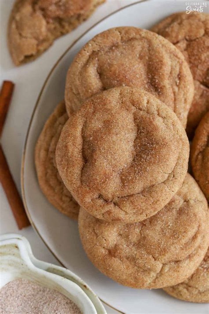 Two halves of maple snickerdoodle cookies stacked on top of each other.
